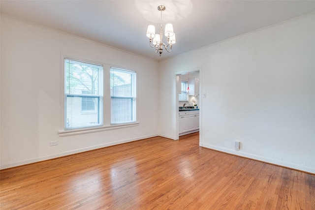 5322 Stoneleigh Ave, Dallas, TX 75235 - unfurnished room with a chandelier, light wood-style flooring, baseboards, ornamental molding, and a sink