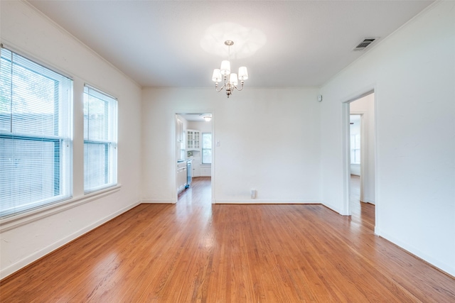 5322 Stoneleigh Ave, Dallas, TX 75235 - spare room featuring a chandelier, light wood-style floors, and healthy amount of natural light