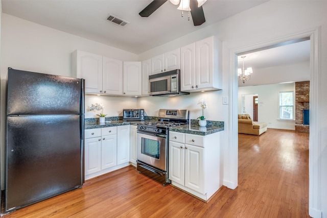5322 Stoneleigh Ave, Dallas, TX 75235 - kitchen featuring stainless steel appliances, dark countertops, white cabinets, light wood finished floors, and a ceiling fan