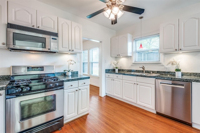 5322 Stoneleigh Ave, Dallas, TX 75235 - kitchen featuring appliances with stainless steel finishes, a sink, and white cabinetry