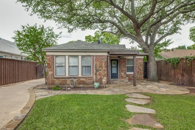 5322 Stoneleigh Ave, Dallas, TX 75235 - view of front facade featuring roof with shingles, brick siding, and stone siding