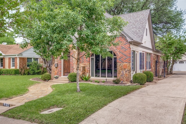 5322 Stoneleigh Ave, Dallas, TX 75235 - view of front facade with a shingled roof, brick siding, a front lawn, stone siding, and concrete driveway