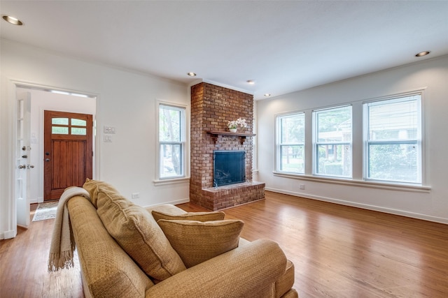 5322 Stoneleigh Ave, Dallas, TX 75235 - living room featuring wood finished floors, baseboards, a brick fireplace, and recessed lighting