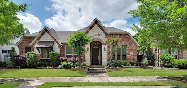 3706 Plum Vista Pl, Arlington, TX 76005 - view of front of house with stone siding, a front yard, brick siding, and a shingled roof