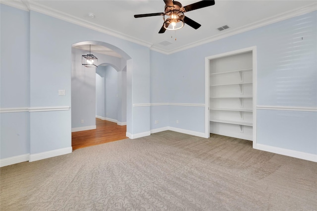 3706 Plum Vista Pl, Arlington, TX 76005 - carpeted empty room with arched walkways, ceiling fan, crown molding, built in features, and baseboards