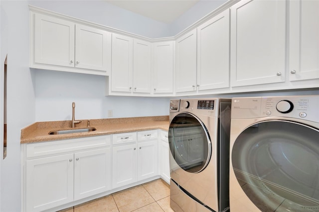 3706 Plum Vista Pl, Arlington, TX 76005 - clothes washing area featuring separate washer and dryer, cabinet space, and light tile patterned floors