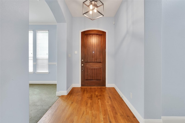 3706 Plum Vista Pl, Arlington, TX 76005 - foyer with arched walkways, baseboards, wood finished floors, and a chandelier