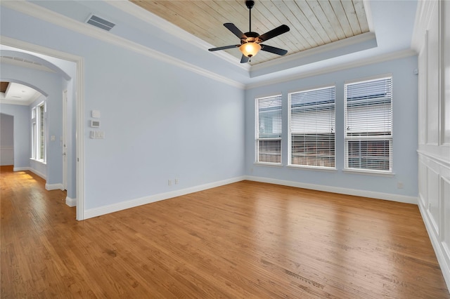 3706 Plum Vista Pl, Arlington, TX 76005 - unfurnished room featuring a tray ceiling, arched walkways, light wood-style floors, plenty of natural light, and wood ceiling