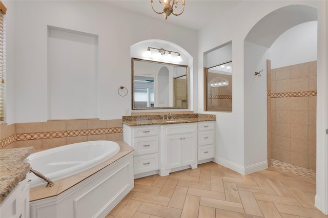3706 Plum Vista Pl, Arlington, TX 76005 - bathroom featuring a walk in shower, a garden tub, vanity, and a chandelier