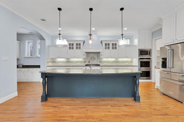 3706 Plum Vista Pl, Arlington, TX 76005 - kitchen with stainless steel appliances, custom range hood, white cabinets, and crown molding