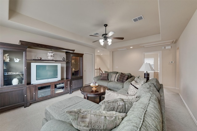 7817 Harvest Hill Ln, Mckinney, TX 75071 - living area with light carpet, a tray ceiling, ceiling fan, and baseboards
