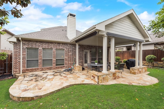 7817 Harvest Hill Ln, Mckinney, TX 75071 - rear view of house featuring brick siding, a patio, a chimney, and a shingled roof