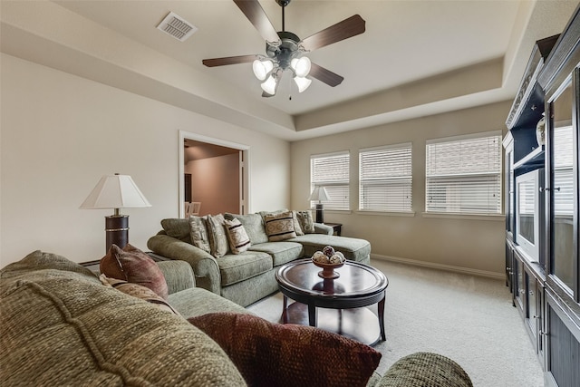 7817 Harvest Hill Ln, Mckinney, TX 75071 - living room featuring light colored carpet, a tray ceiling, baseboards, and ceiling fan