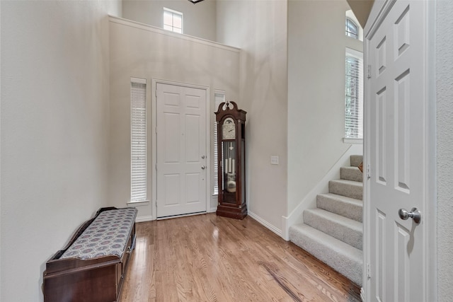 7817 Harvest Hill Ln, Mckinney, TX 75071 - entryway featuring light wood finished floors, a high ceiling, stairway, and baseboards