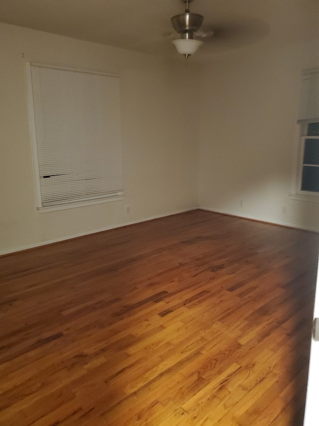 1600 N Frances St, Terrell, TX 75160 - empty room with wood finished floors, ceiling fan, and baseboards