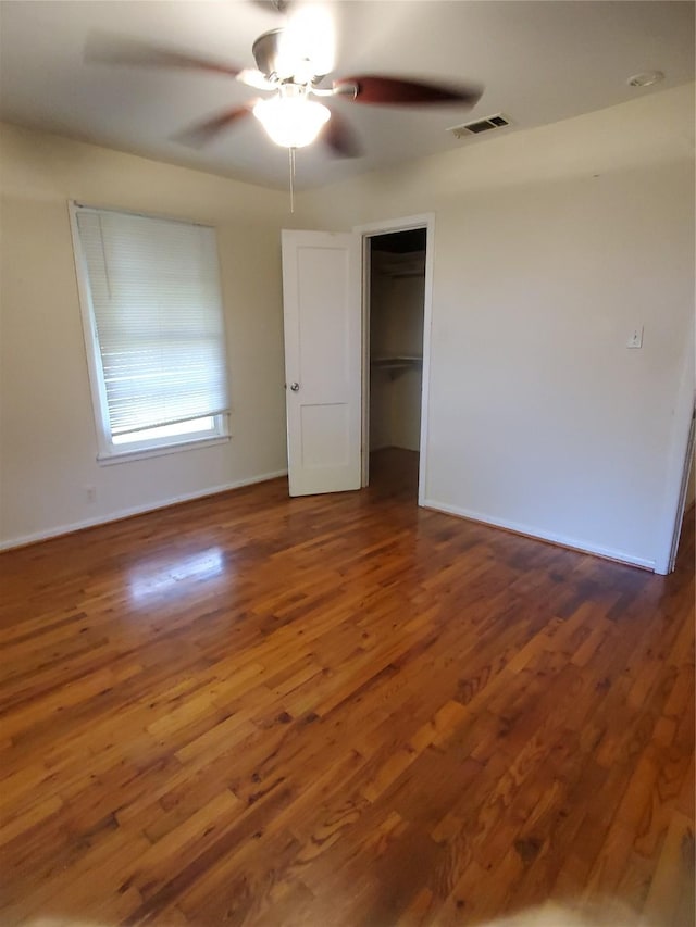 1600 N Frances St, Terrell, TX 75160 - unfurnished bedroom featuring wood finished floors, a ceiling fan, and baseboards