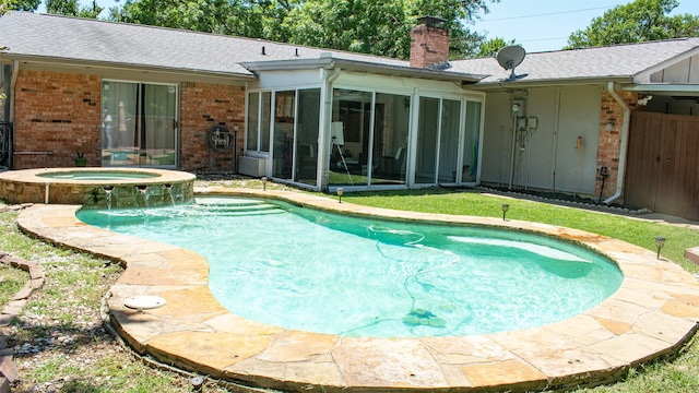 view of pool featuring a sunroom and a pool with connected hot tub