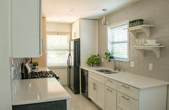 kitchen featuring black appliances, open shelves, a sink, and decorative backsplash