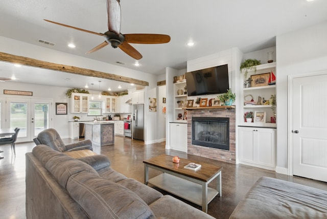 living area with ceiling fan, a brick fireplace, recessed lighting, finished concrete flooring, and baseboards