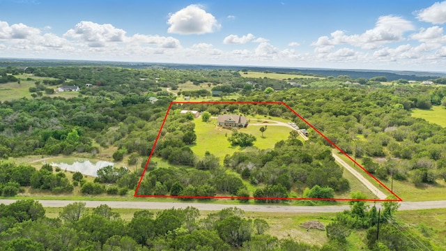 view of property location featuring property parcel outlined, a large body of water, and a heavily wooded area