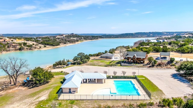 bird's eye view of a nearby body of water and a pool area