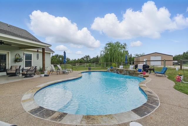 view of pool with fence, a patio, and a ceiling fan