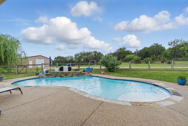 view of pool featuring a patio area and an outbuilding