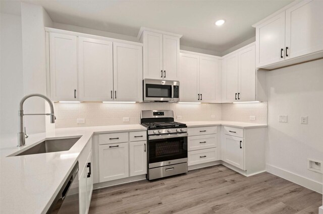 4702 Smokey Quartz Ln, Arlington, TX 76005 - kitchen with stainless steel appliances, a sink, white cabinetry, decorative backsplash, and recessed lighting
