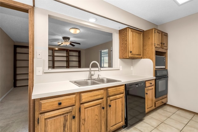 kitchen with black appliances, a sink, light countertops, brown cabinetry, and a textured ceiling
