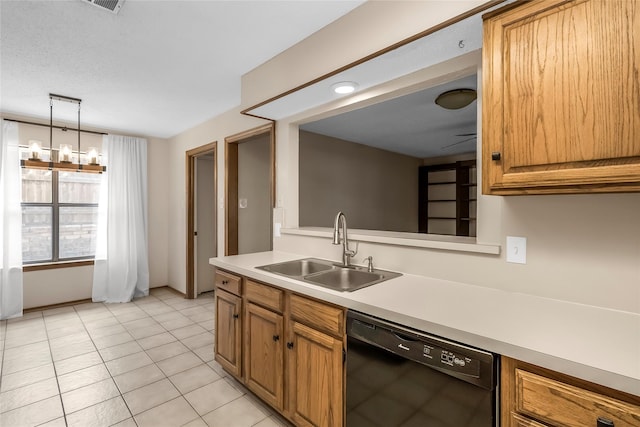 kitchen featuring dishwasher, a sink, light countertops, brown cabinets, and hanging light fixtures
