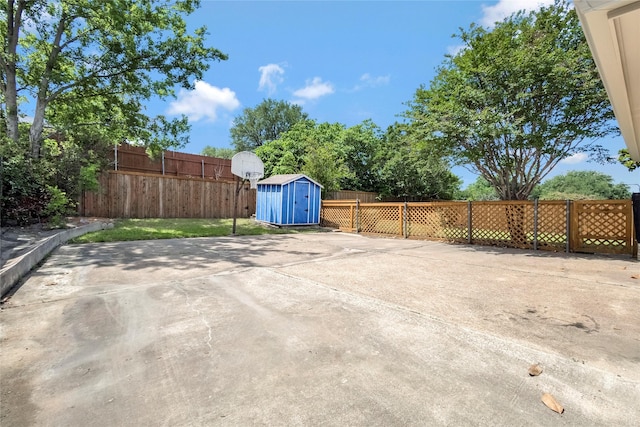 view of patio featuring a shed, an outbuilding, and a fenced backyard