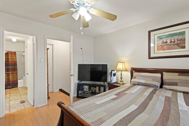 449 Harris St Unit 102D, Coppell, TX 75019 - bedroom with light wood-type flooring, a ceiling fan, and baseboards
