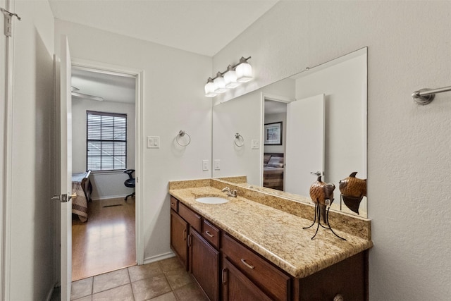 449 Harris St Unit 102D, Coppell, TX 75019 - ensuite bathroom featuring vanity, baseboards, and tile patterned floors