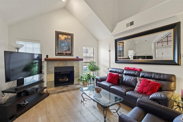 449 Harris St Unit 102D, Coppell, TX 75019 - living area with healthy amount of natural light, wood finished floors, a fireplace, and high vaulted ceiling