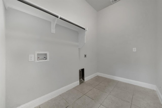 laundry room with hookup for an electric dryer, hookup for a washing machine, light tile patterned floors, and baseboards