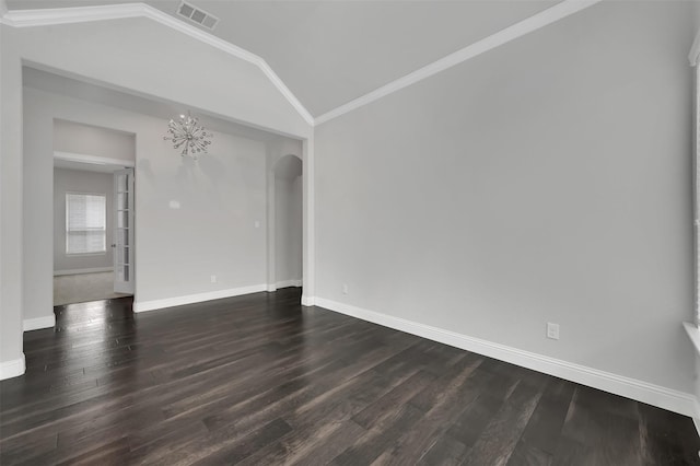 empty room with vaulted ceiling, arched walkways, dark wood-style floors, baseboards, and a chandelier