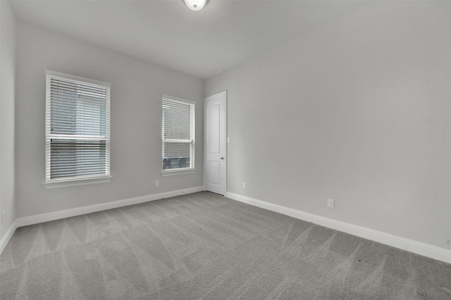 carpeted spare room with baseboards