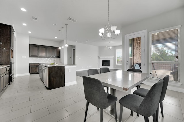 dining space with baseboards, a chandelier, recessed lighting, a fireplace, and light tile patterned flooring