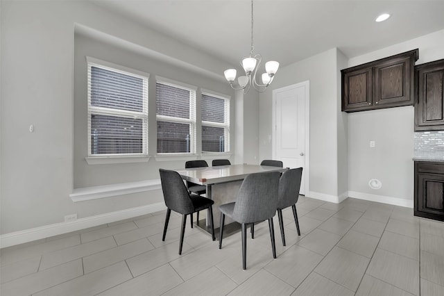 dining room featuring a chandelier, baseboards, and light tile patterned flooring