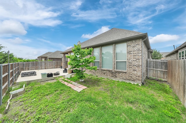 back of property featuring brick siding and a patio area