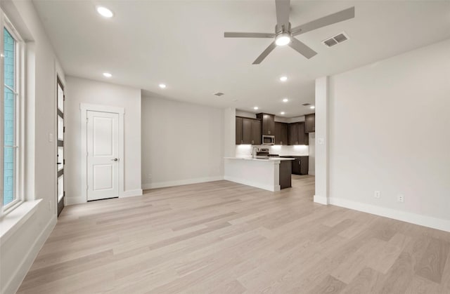 4732 Smokey Quartz Ln, Arlington, TX 76005 - unfurnished living room featuring light wood-style flooring, recessed lighting, baseboards, and a ceiling fan