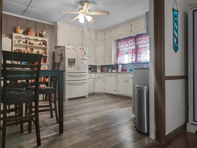 401 S 9th Ave, Teague, TX 75860 - kitchen with white refrigerator with ice dispenser, ceiling fan, wood finished floors, and light countertops