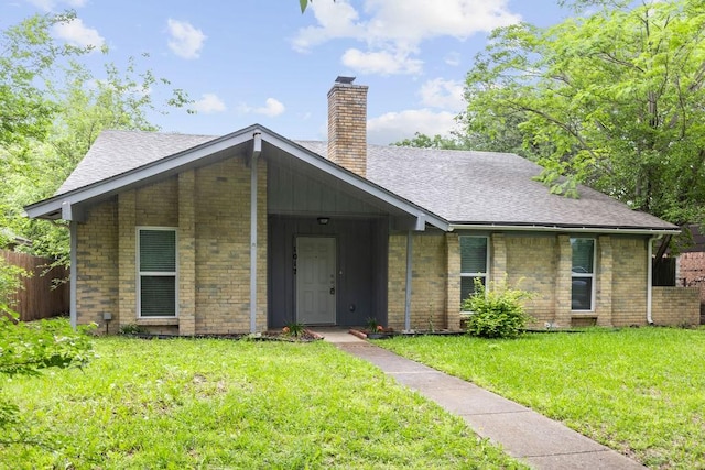 1017 Westminster Ln, Garland, TX 75040 - view of front of house with a chimney, a shingled roof, and brick siding