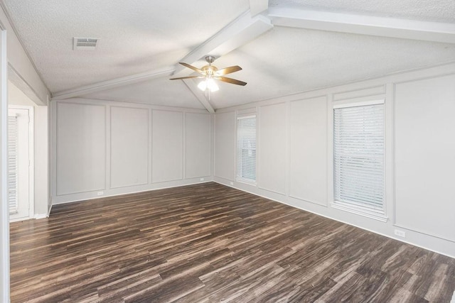 1017 Westminster Ln, Garland, TX 75040 - empty room with a decorative wall, dark wood finished floors, ceiling fan, and a textured ceiling