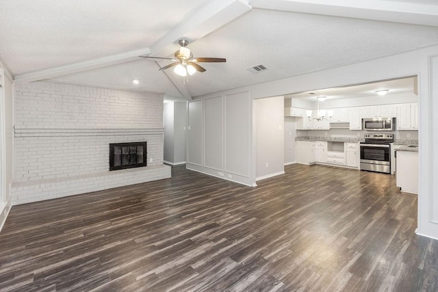 1017 Westminster Ln, Garland, TX 75040 - unfurnished living room featuring a ceiling fan, a brick fireplace, dark wood-type flooring, brick wall, and baseboards