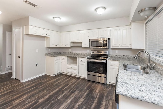 1017 Westminster Ln, Garland, TX 75040 - kitchen with stainless steel appliances, a sink, dark wood-style flooring, light stone counters, and white cabinetry