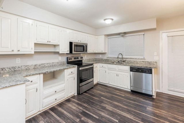 1017 Westminster Ln, Garland, TX 75040 - kitchen with appliances with stainless steel finishes, open shelves, a sink, and dark wood finished floors