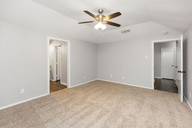 1017 Westminster Ln, Garland, TX 75040 - unfurnished bedroom featuring carpet flooring, baseboards, a ceiling fan, vaulted ceiling, and a textured ceiling