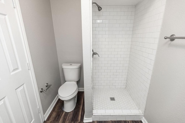 1017 Westminster Ln, Garland, TX 75040 - full bath with a stall shower, toilet, and wood finished floors