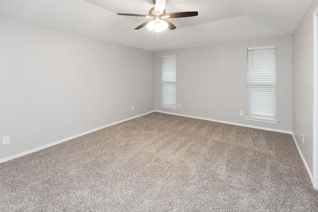 1017 Westminster Ln, Garland, TX 75040 - spare room with carpet flooring, a ceiling fan, vaulted ceiling, and baseboards